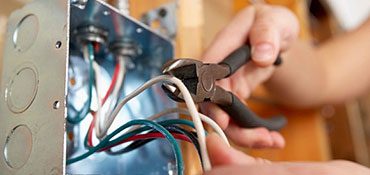 Wires and cutters in a wall socket